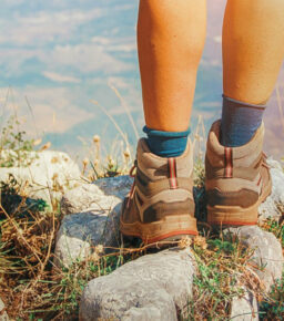 Close up of women legs wearing hiking boots in mountain